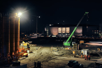 Building site excavator crane night berlin big silo - Powered by Adobe