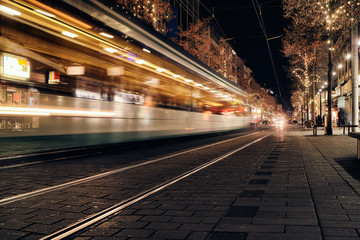 Fototapeta na wymiar Time Exposure train traffic light night Mannheim street urban public transport city christmas holiday shopping asphalt