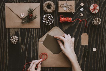 Christmas handmade cards and gifts. Hand making christmas card on wooden table, top view