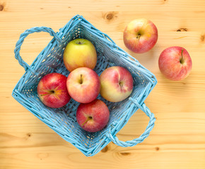 Red apples in blue wooden basket