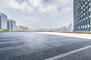 Panoramic skyline and modern business office buildings with empty road,empty concrete square floor
