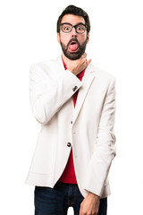 Brunette man with glasses drowning himself on white background