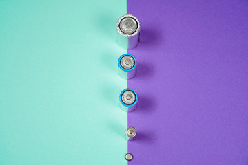 Many different types used or new battery, rechargeable accumulator, alkaline batteries on color...