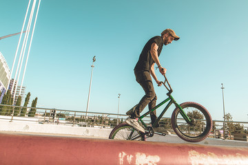 BMX rider doing tricks in the streets