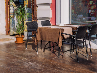A table with a chair chairs near the window of a summer cafe.