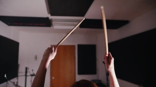 Dashing girl with black hair percussion drummer starts playing drums