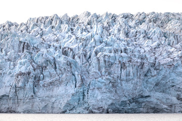 Isfjorden glacier front of blue ice in Svalbard on a summer day. © Kertu