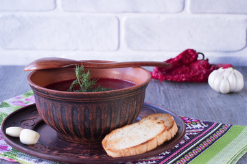 Borsch in brown bowl. Red soup. Dsh of Slavic, Russian, Ukrainian cuisine.