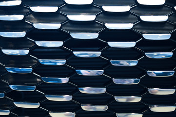 blue radiator grille of new modern car in automobile showrooom
