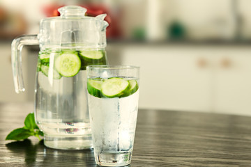 Pitcher with glass of cucumber water