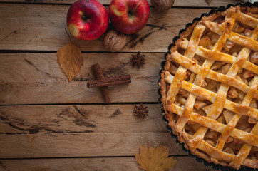 Homemade apple pie on wooden background, top view, copy space