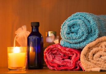 Rolled towels with aromatic candle.