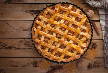 Homemade apple pie on wooden background, top view, copy space