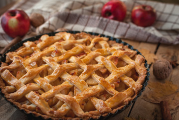 Close-up of homemade apple pie on wooden background