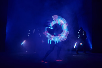 Laser show performance, dancers in led suits with LED lamp, very beautiful night club performance, party