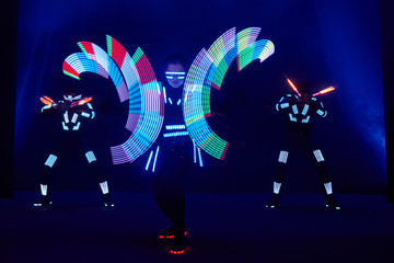 Laser show performance, dancers in led suits with LED lamp, very beautiful night club performance, party