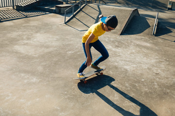 Skateboarder doing ollie at skatepark