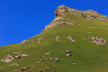 Fototapeta na wymiar Stone ledge of a rocky ridge against the blue sky.