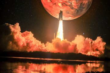 Lighting up the night sky, as well as the water nearby, spacship blazes into the Mars mission. Huge...