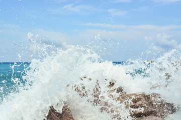 Waves splash against rocks on beach