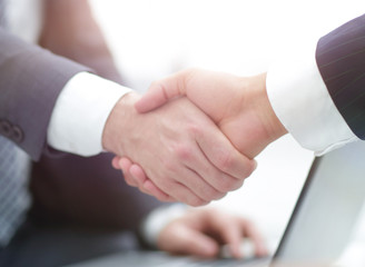 Closeup of business people shaking hands over a deal