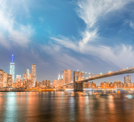 Fototapeta na wymiar Manhattan lights at sunset, river reflections
