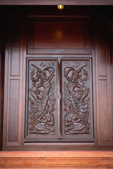 wood carving on the wall of temple in Thailand.