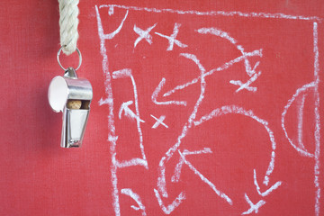 whistle of a soccer / football referee or trainer with match strategy diagram scribble