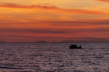 Fishing boat come back from fishing at sunset, Italy