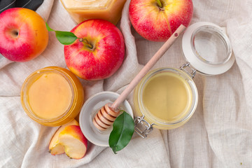 Jewish holiday Rosh Hashanah background with honey and apples on wooden table.