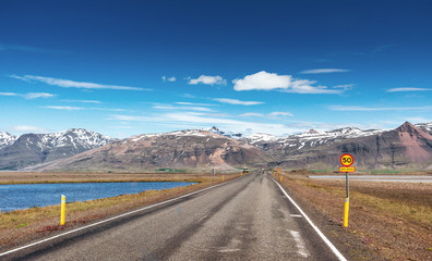 Road in mountains. Bridge over a channel connecting Jokulsarlon Lagoon and Atlantic Ocean in southern Iceland