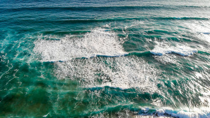 Ocean waves overhead aerial view on a sunny day