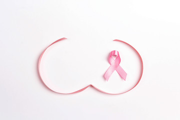 Pink ribbon with breast shape symbol on white background. Breast cancer awareness symbol.