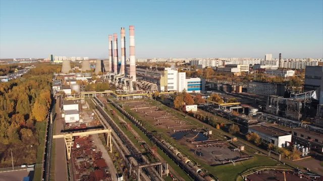 Aerial view of the Industrial Plant with Smoking Pipes near the City. Industrial zone. View from the drone to the factory.