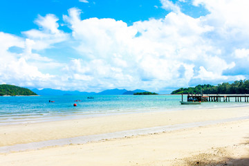 Closeup of boat in sea with island and blue sky and white cloud in thailand