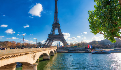 Obraz premium PARIS, FRANCE - DECEMBER 2012: Tourists visit Eiffel Tower. The city attracts 40 million people every year