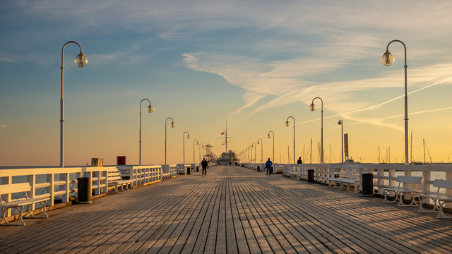 Fototapeta The Sopot Pier in the city of Sopot. The pier is the longest wooden pier in Europe. Beautiful sunrise.