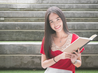 Young Asian female student with notebooks in her hands.A portrait of an Asian college student.education and learning concept.