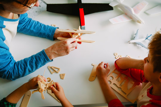 teacher and kids making toy planes, learning concept