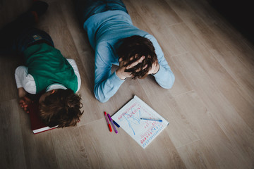 father and son stressed tired of doing homework together