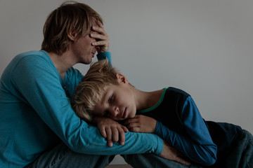 sad child with stressed father, family problems, sorrow
