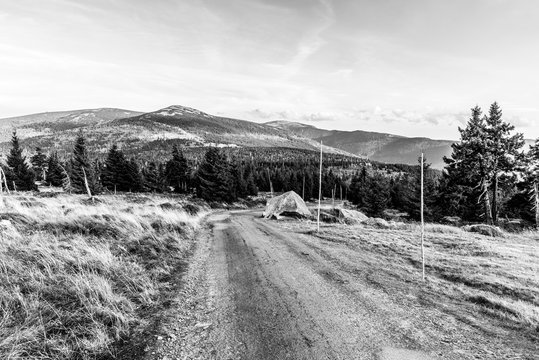 Tourist road in the middle of mountain landscape, Giant Mountains, Krkonose, Czech Republic. Black and white image.