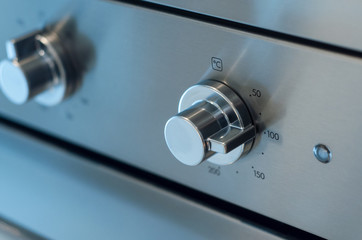closeup of oven dashboard with grey buttons