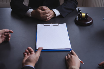 Attractive asian couple consulting a lawyer about contract agreement,blank white documents for graphic montage.