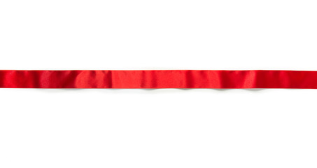 Extending simple red ribbon with typical ripples or wrinkles of a silky or satin ribbon , isolated on white.