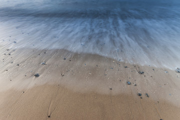 Waves on the beach with pebbles