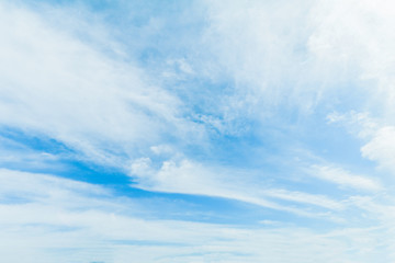 Clear blue sky background with white clouds.