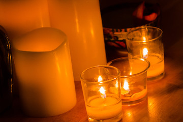 Lit candles warming up a dark room