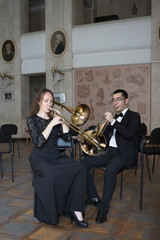 Two musicians playing on wind instruments
