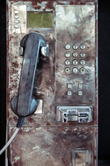 Close up Old Grungy Orange Public Payphone
